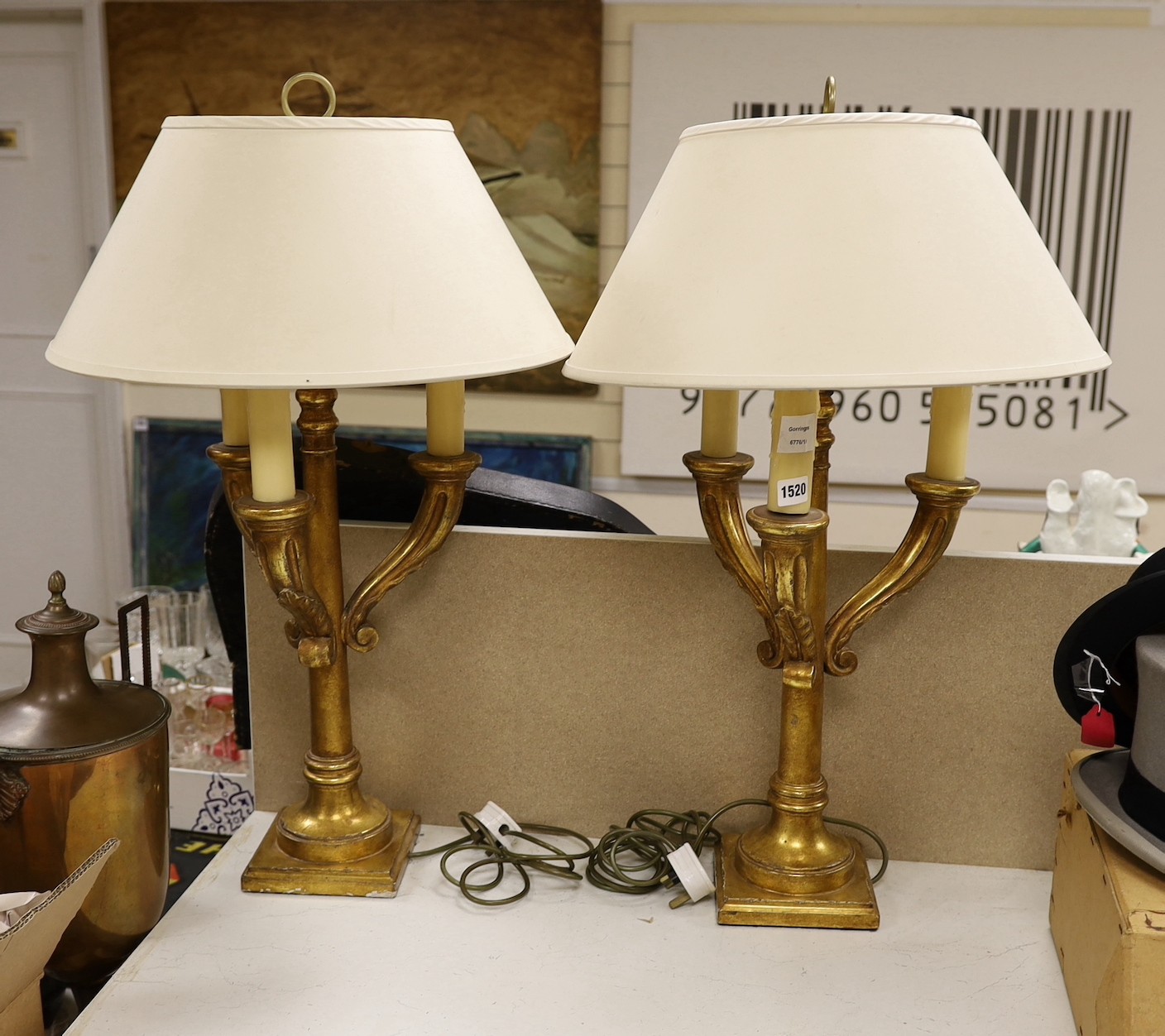 A pair of giltwood three branch lamps, 76 cms high